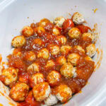 frozen meatballs cooked in the crock pot with peach jam and chili sauce for an appetizer or easy dinner