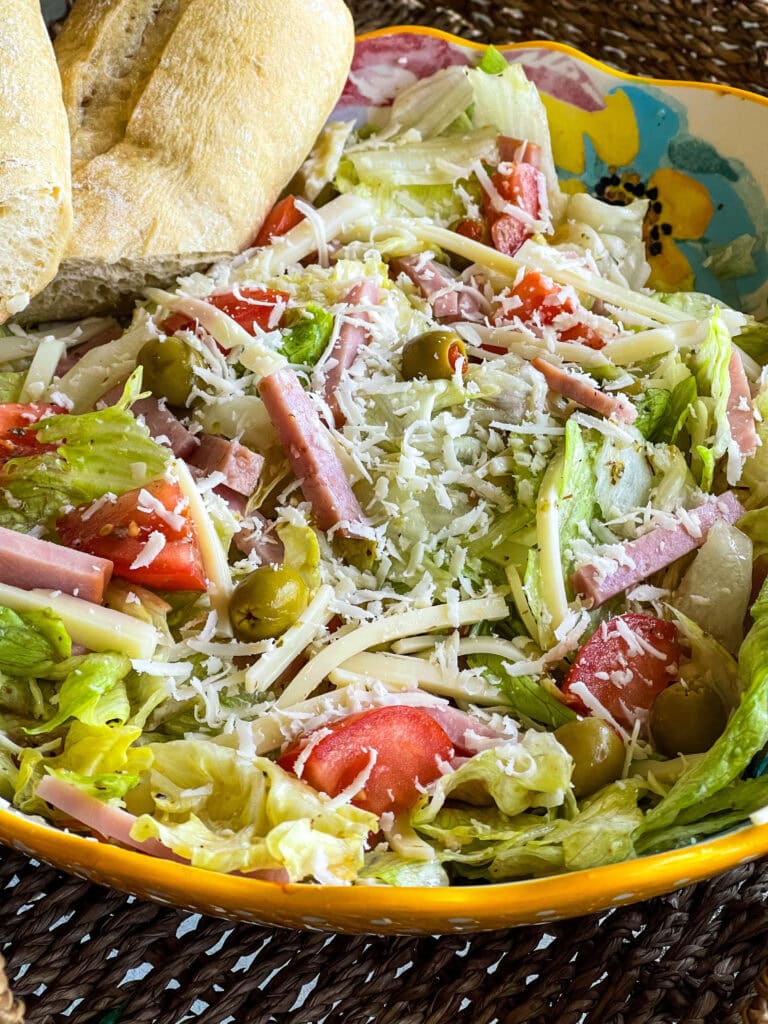 The Columbia Restaurant 1905 Salad with iceburg lettuce, tomatoes, Swiss cheese, olives, ham and a vinaigrette