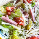 The Columbia Restaurant 1905 Salad with iceburg lettuce, tomatoes, Swiss cheese, olives, ham and a vinaigrette