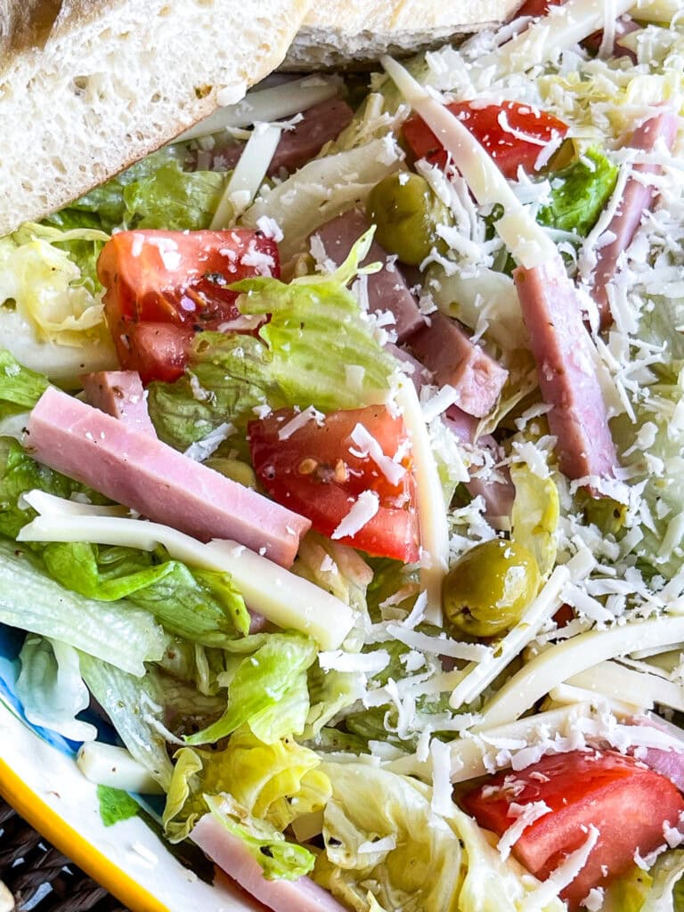 The Columbia Restaurant 1905 Salad with iceburg lettuce, tomatoes, Swiss cheese, olives, ham and a vinaigrette
