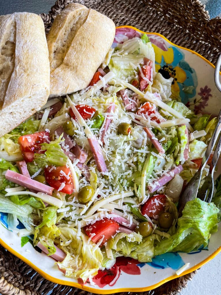The Columbia Restaurant 1905 Salad with iceburg lettuce, tomatoes, Swiss cheese, olives, ham and a vinaigrette