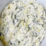 If you’re looking for a no-fuss appetizer that delivers big flavor with minimal effort, this Crock Pot Spinach Artichoke Dip is your go-to.