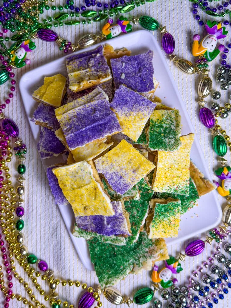 cracker toffee made with white chocolate chips and sprinkled with yellow, green and purple sugar for Mardi Gras