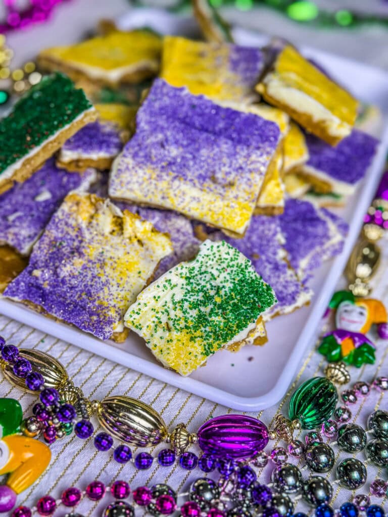 cracker toffee made with white chocolate chips and sprinkled with yellow, green and purple sugar for Mardi Gras