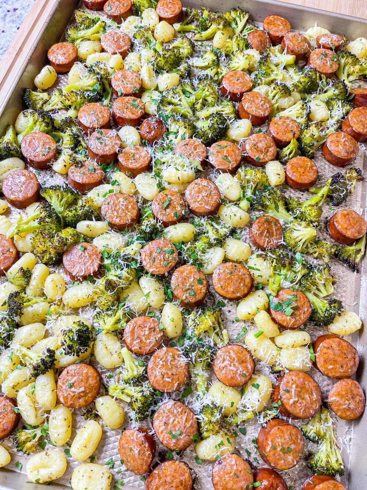 A full meal on a pan; my kind of dinner! This easy Sheet Pan Sausage and Gnocchi recipe is the perfect weeknight dinner that includes spicy andouille sausage, gnocchi and herbed broccoli, on the table in less than 30 minutes.