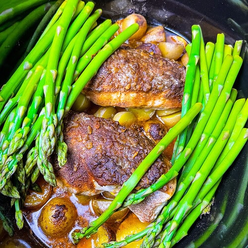 Your slow cooker will do all the work for dinner tonight! This family-favorite Crock Pot Buttery Onion Chicken is a regular on my dinner rotation. Tender, flavorful chicken, buttery potatoes, and perfectly crisp-tender asparagus come together in an all-in-one, dump and cook meal. It’s a set-it-and-forget-it dinner the whole family will love!