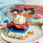 Looking for a no-fuss, festive treat for the 4th of July? This Patriotic Pretzel Salad is a salty-sweet layered dessert that combines crunchy pretzels, creamy whipped topping, and vibrant red and blue Jell-O bursting with fruit. It’s a fun twist on the nostalgic classic and always a crowd favorite!