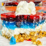 Looking for a no-fuss, festive treat for the 4th of July? This Patriotic Pretzel Salad is a salty-sweet layered dessert that combines crunchy pretzels, creamy whipped topping, and vibrant red and blue Jell-O bursting with fruit. It’s a fun twist on the nostalgic classic and always a crowd favorite!