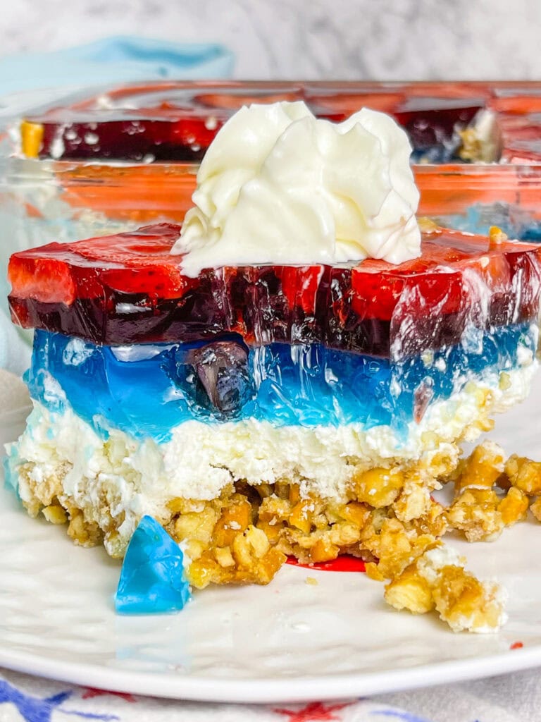 Looking for a no-fuss, festive treat for the 4th of July? This Patriotic Pretzel Salad is a salty-sweet layered dessert that combines crunchy pretzels, creamy whipped topping, and vibrant red and blue Jell-O bursting with fruit. It’s a fun twist on the nostalgic classic and always a crowd favorite!