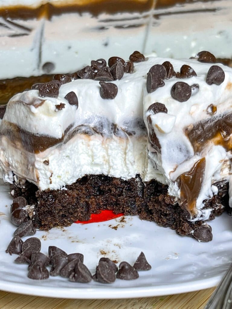 This Chocolate Lasagna dessert with a brownie crust is the ultimate chocolate lover's treat! It has a layer of rich fudgy brownie, a tangy cream cheese layer, a cool and creamy chocolate pudding layer and is topped off with whipped cream and mini chocolate chips. Perfect for a party, potluck, or get-together!
