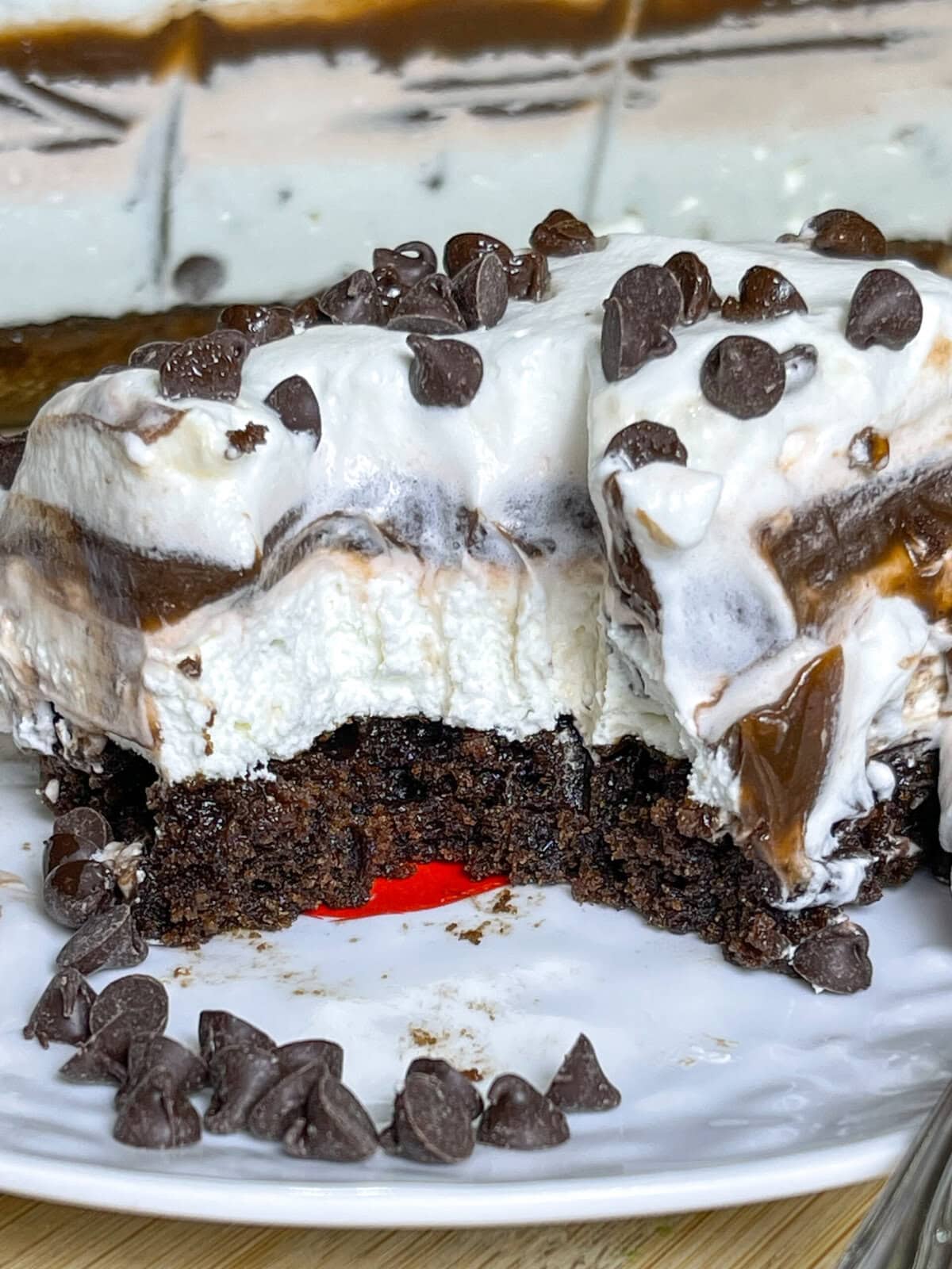 This Chocolate Lasagna dessert with a brownie crust is the ultimate chocolate lover's treat! It has a layer of rich fudgy brownie, a tangy cream cheese layer, a cool and creamy chocolate pudding layer and is topped off with whipped cream and mini chocolate chips. Perfect for a party, potluck, or get-together!