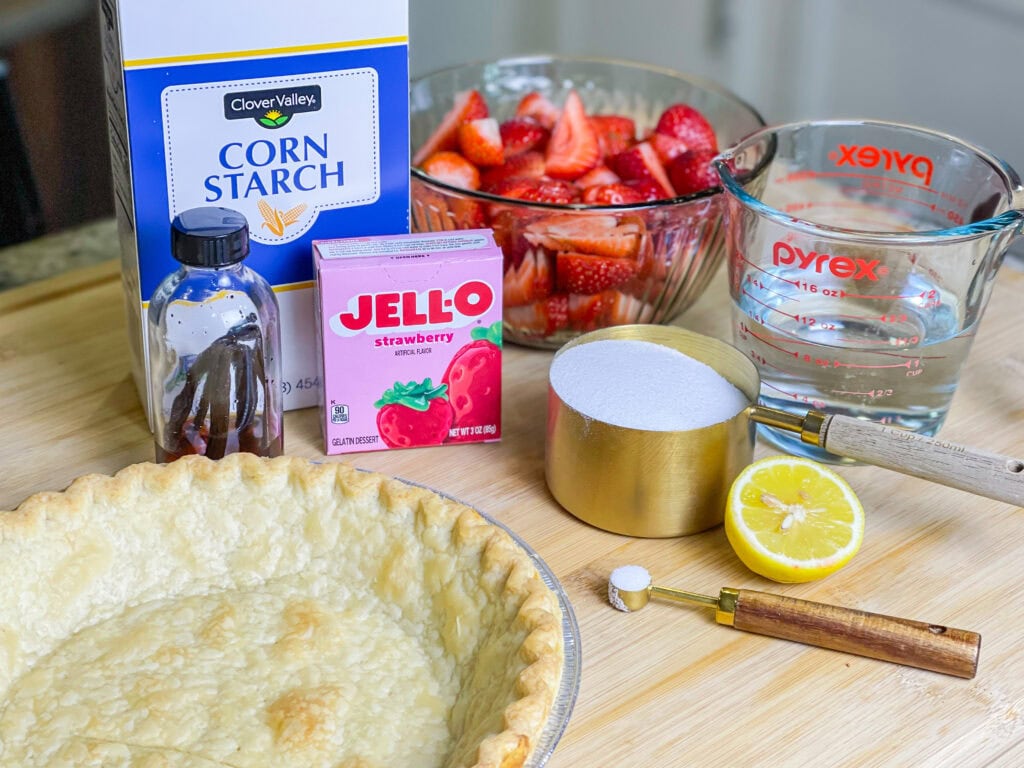 strawberry pie made with a store bought pie crust, fresh strawberries and a homemade strawberry glaze topped with whipped cream.