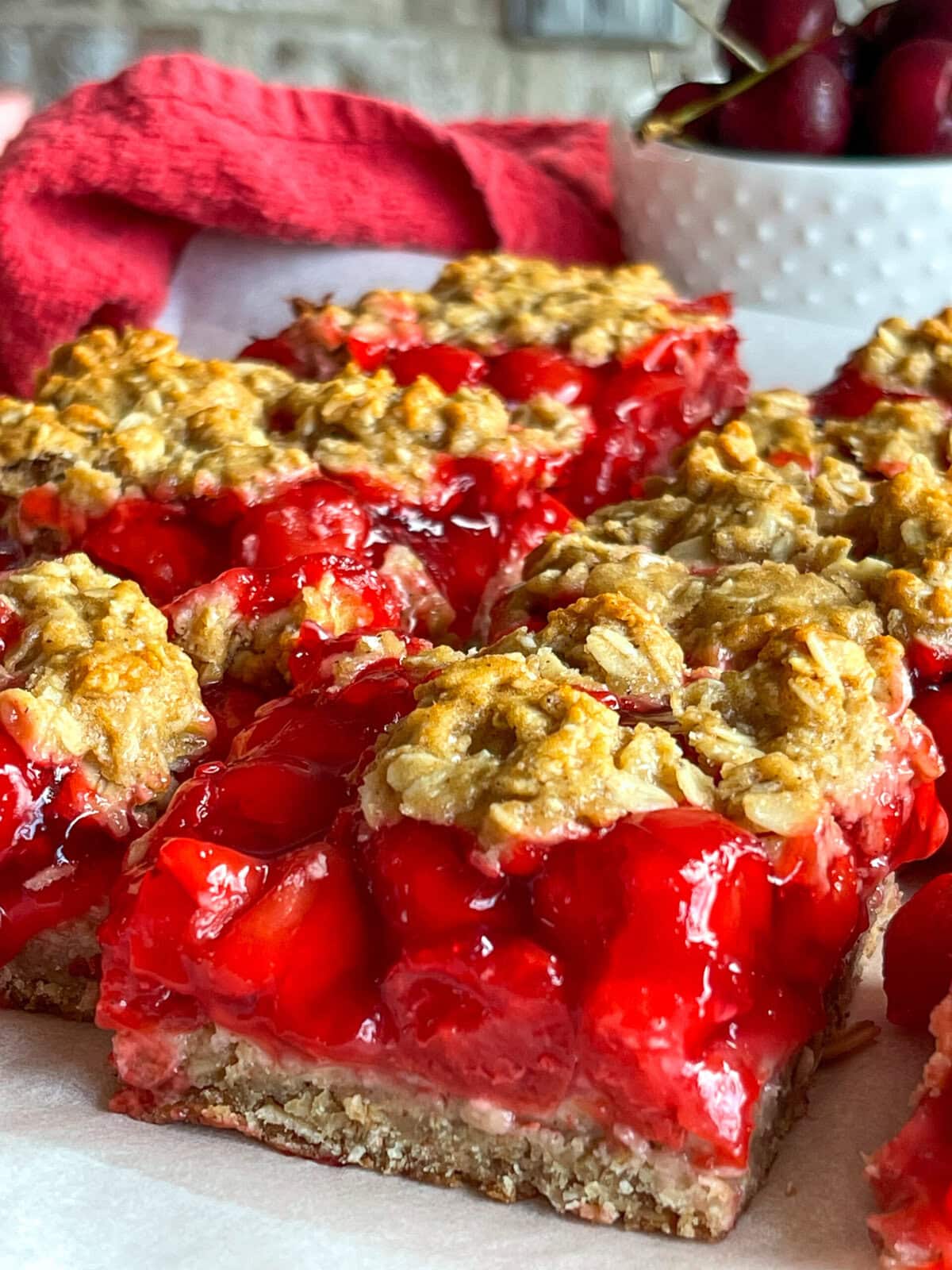 Cherry Apple Oat Bars have a chewy oat crust, sweet-tart cherry apple fruit filling, and a crumbly crunchy oat topping.