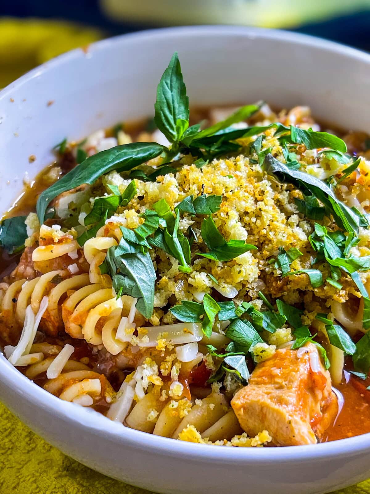 This Slow Cooker Chicken Parmesan Soup is cheesy, hearty, and topped with crispy breadcrumbs for that classic Chicken Parm crunch!