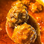 ground meat stuffed with rice slow cooked in a tomato based sauce