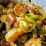 Close-up of shrimp and sausage in the slow cooker with seasoned potatoes.