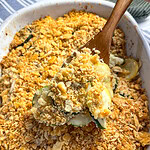 zucchini and yellow squash in a cheesy casserole with a Ritz cracker crumb topping in a 9x13 white baking dish