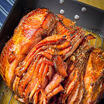 Spiral-sliced ham with caramelized honey glaze on serving platter