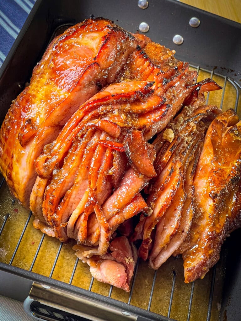 Spiral-sliced ham with caramelized honey glaze on serving platter