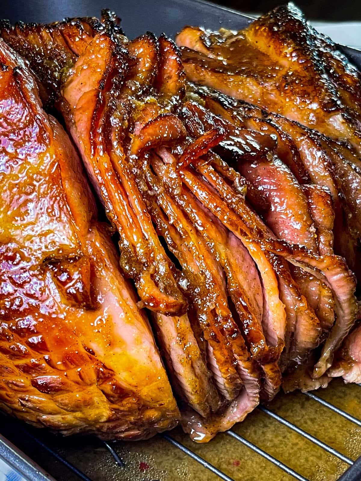 Spiral-sliced ham with caramelized honey glaze on serving platter