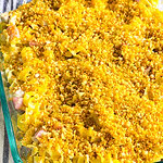 A golden-brown Chicken Cordon Bleu Casserole topped with crispy breadcrumbs and melted Swiss cheese in a white baking dish.