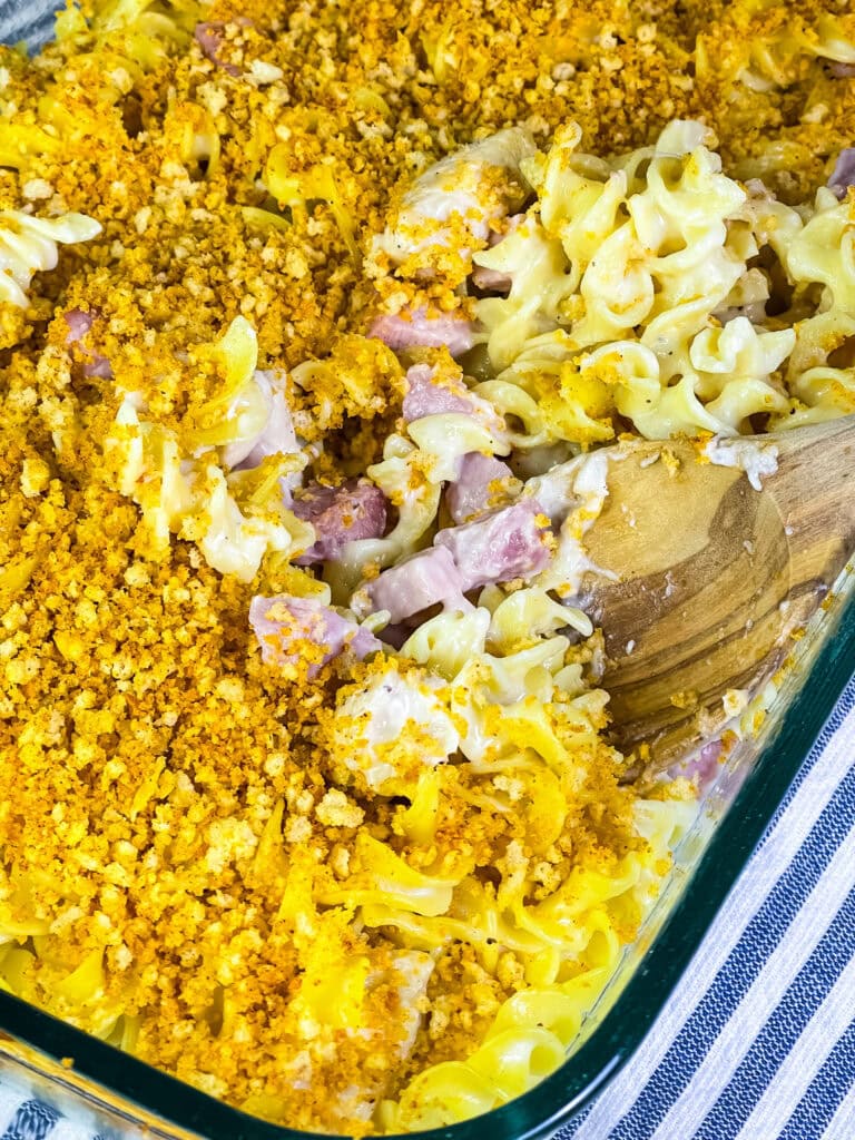 Close-up of a creamy Chicken Cordon Bleu Casserole with chicken, ham, and noodles under a toasted Panko topping.