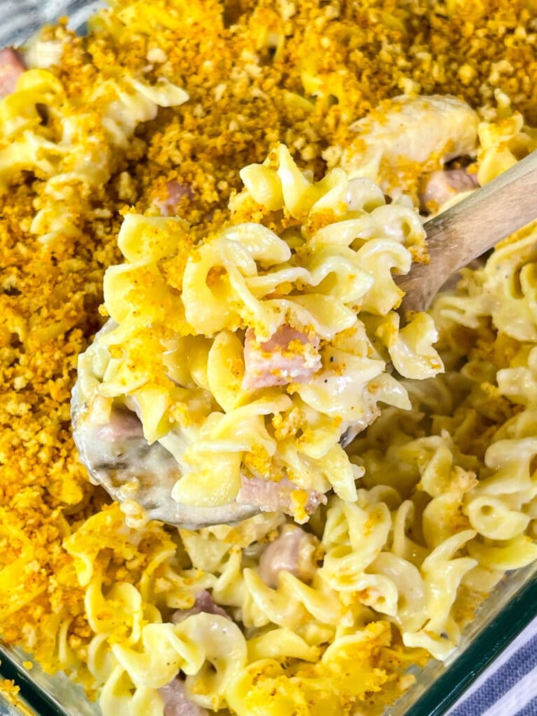 Close-up of a creamy Chicken Cordon Bleu Casserole with chicken, ham, and noodles under a toasted Panko topping.