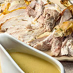 carved turkey slices with gravy over top