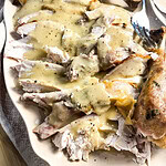carved turkey slices with gravy over top