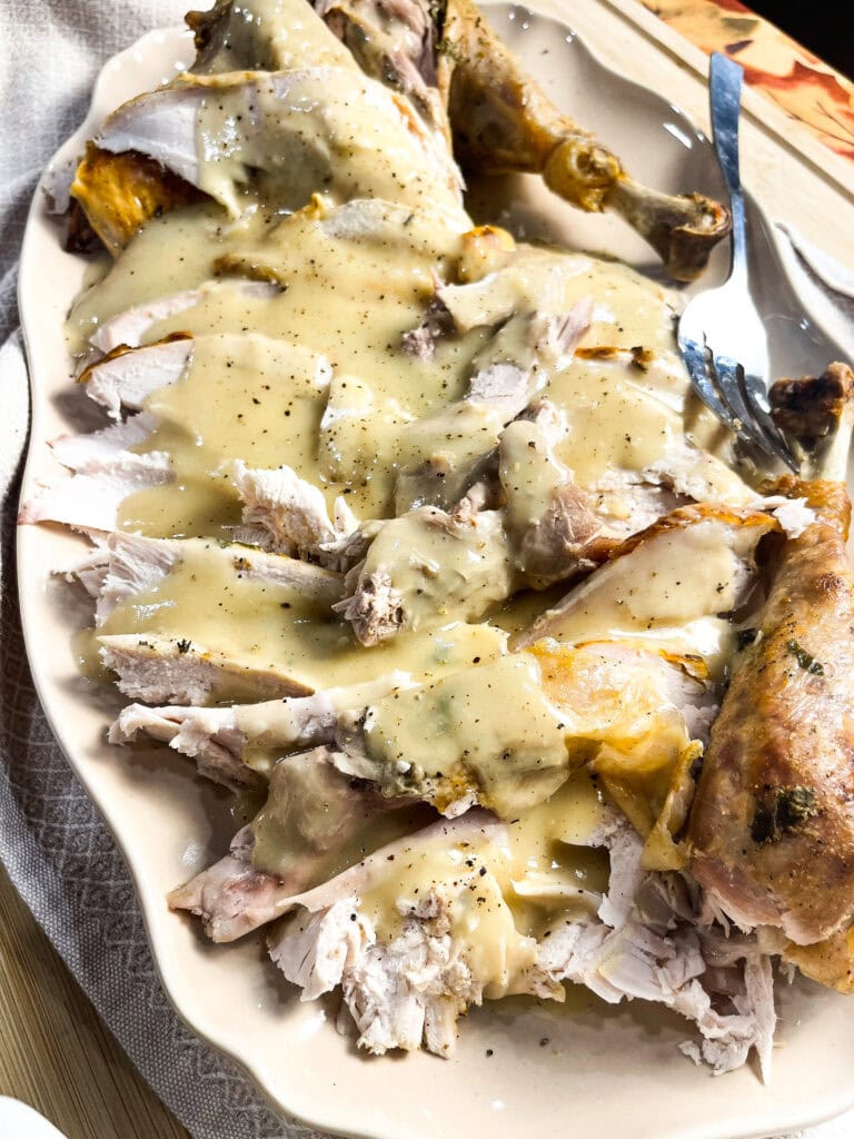carved turkey slices with gravy over top