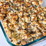 homemade stuffing with celery and mushrooms in a glass baking dish