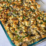 homemade stuffing with celery and mushrooms in a glass baking dish
