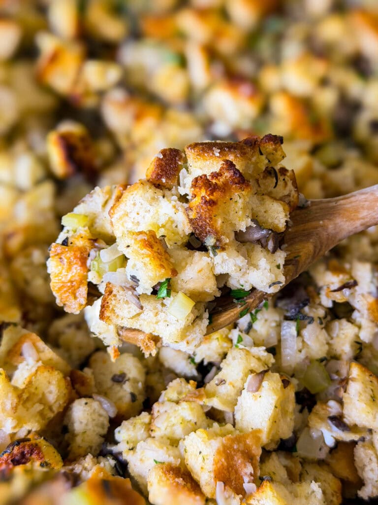 homemade stuffing with celery and mushrooms in a glass baking dish