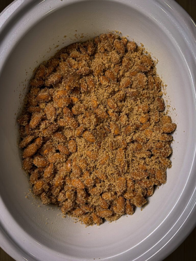 almonds coated in cinnamon and sugar in a crock pot