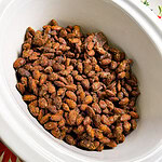 almonds coated in cinnamon and sugar in a crock pot