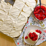 Prepared white cake mix with a white cream cheese frosting topped with cherry pie filling