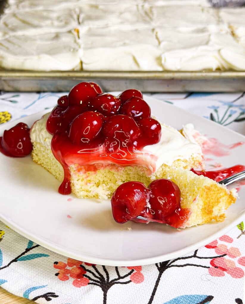 Prepared white cake mix with a white cream cheese frosting topped with cherry pie filling