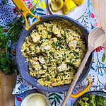 creamy chicken piccata with orzo being served from a yellow skillet