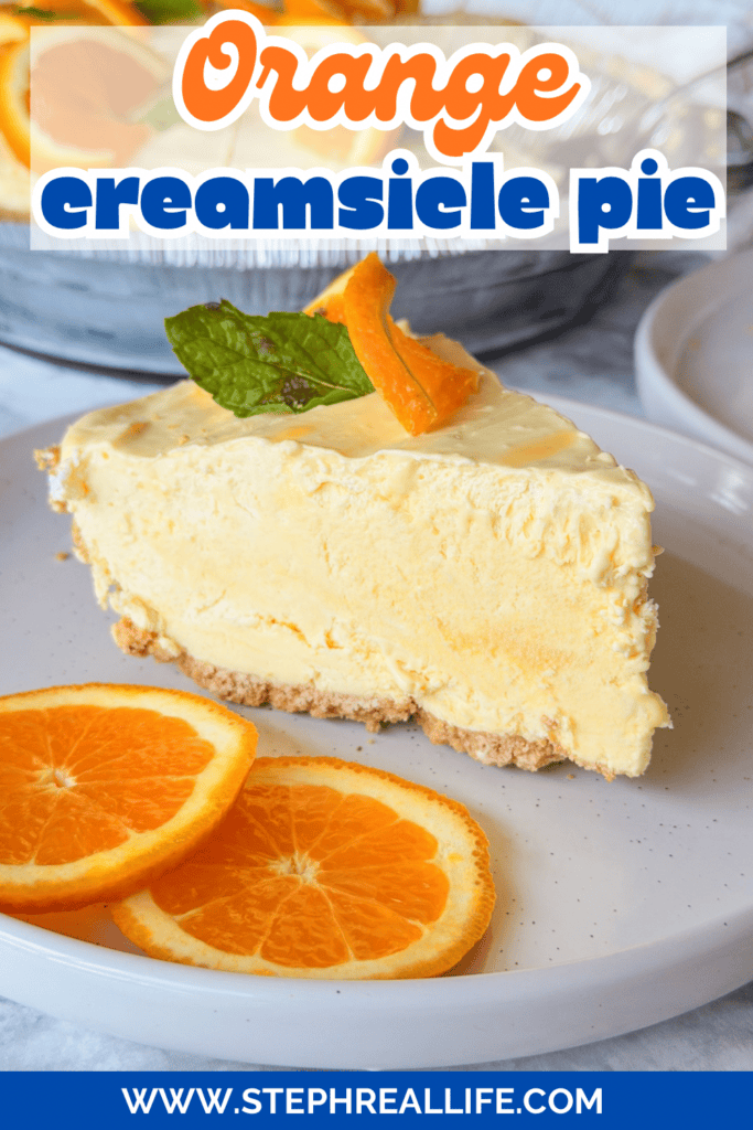 A slice of orange creamsicle pie sits on a plate, garnished with a mint leaf and orange slice, with two orange slices beside it. Text on the image reads Orange creamsicle pie and www.stephreallife.com.