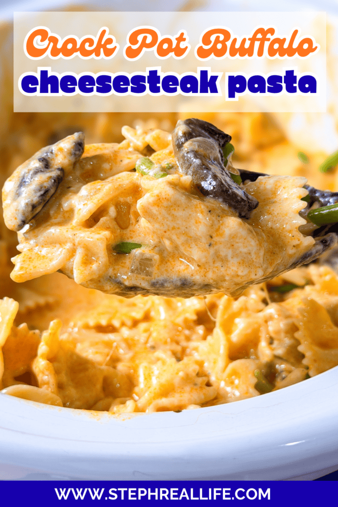 A spoonful of creamy bowtie pasta with mushrooms and sauce is lifted from a bowl. Text reads Crock Pot Buffalo cheesesteak pasta and www.stephreallife.com..