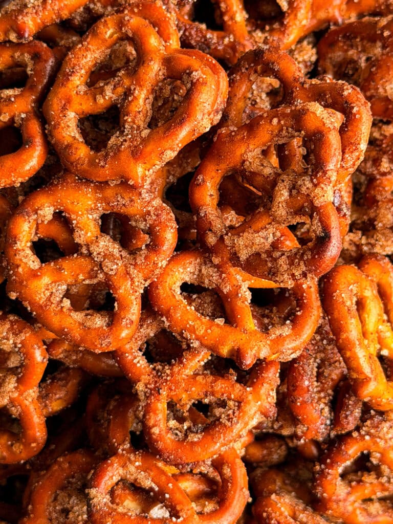 A pile of golden-brown pretzels coated in cinnamon sugar.